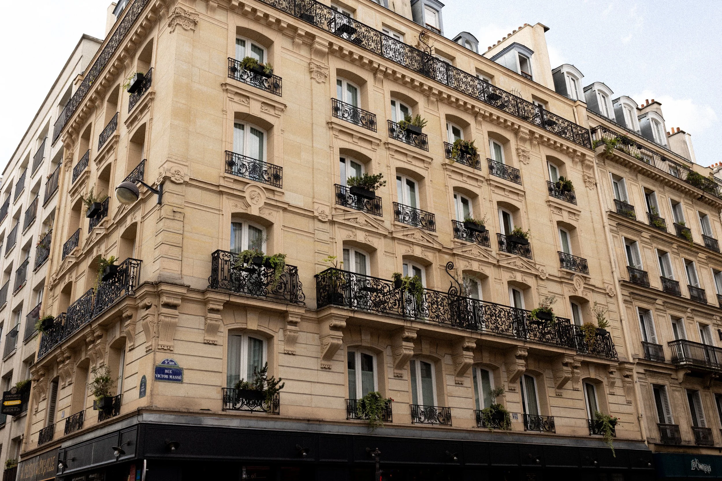 A patterned floor and striped fabrics inside a corner building in Paris
