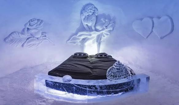 Ice sculpture and reindeer hides in a frozen sleeping chamber in northern Norway